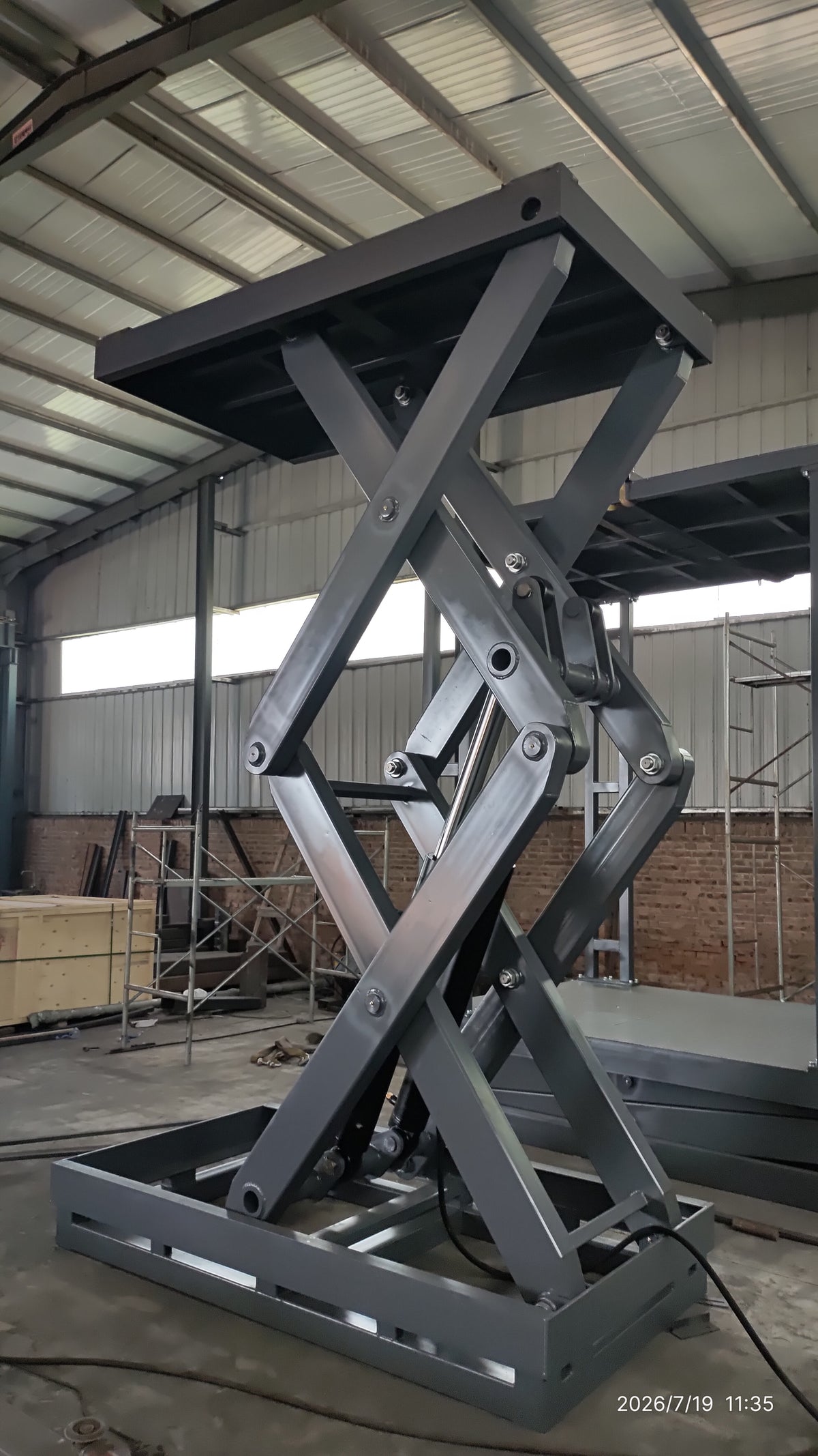 5-ton double scissor structure lift raised to full height — front-angle view showing dual-layer scissor structure and steel platform